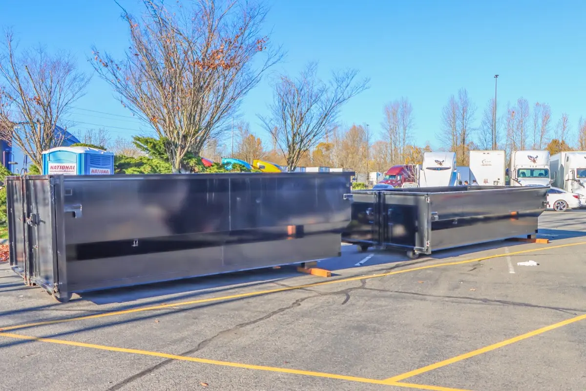 Professional dumpster rental service with roll-off container on residential driveway in Granville